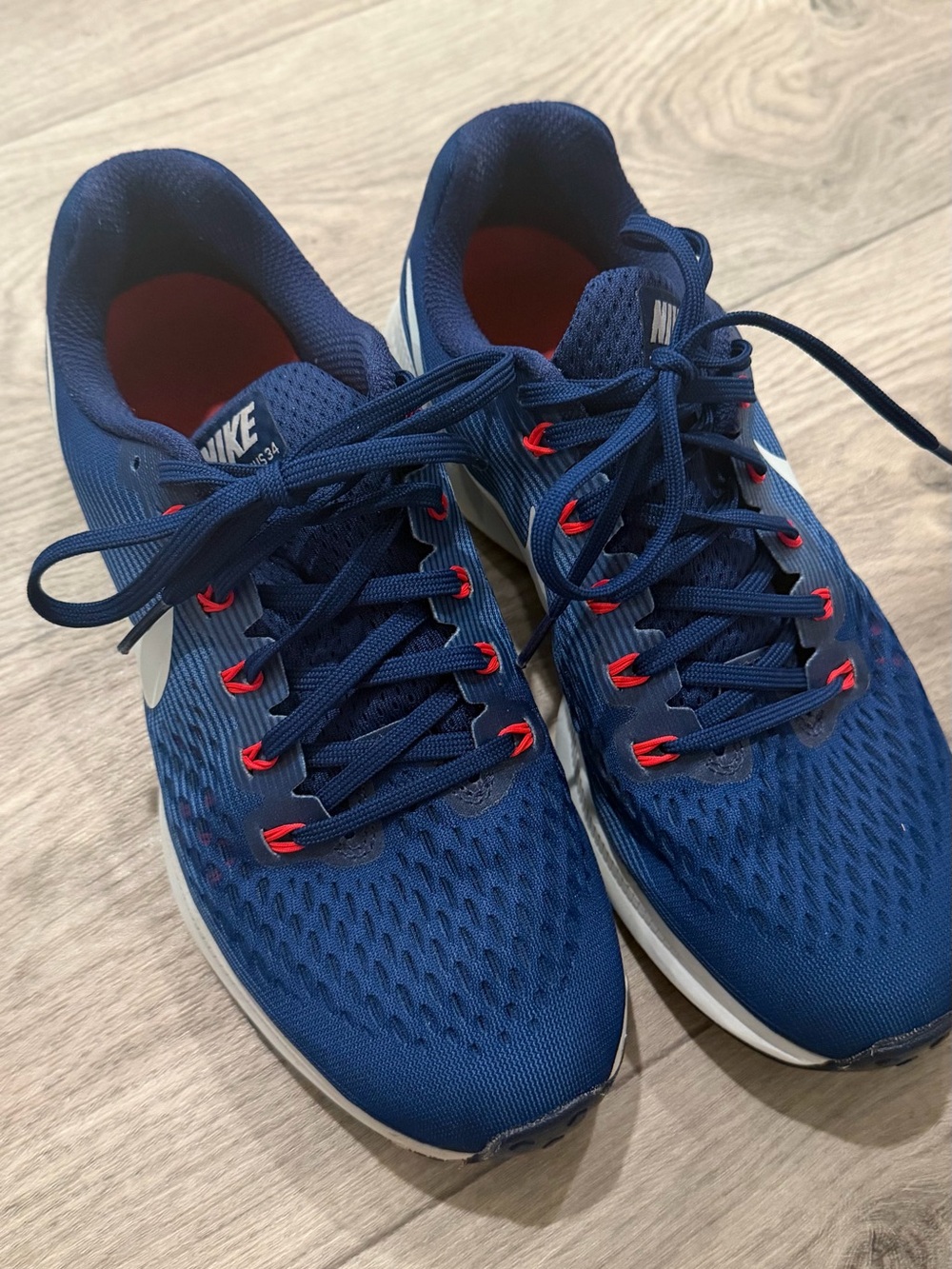 Nike Blue Running Shoes with Red Accents and White Swoosh